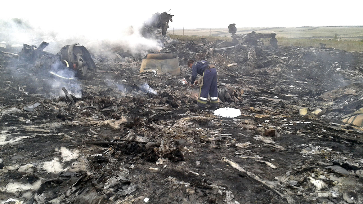 Emergencies Ministry member works at the site of a Malaysia Airlines Boeing 777 plane crash in the settlement of Grabovo in the Donetsk region