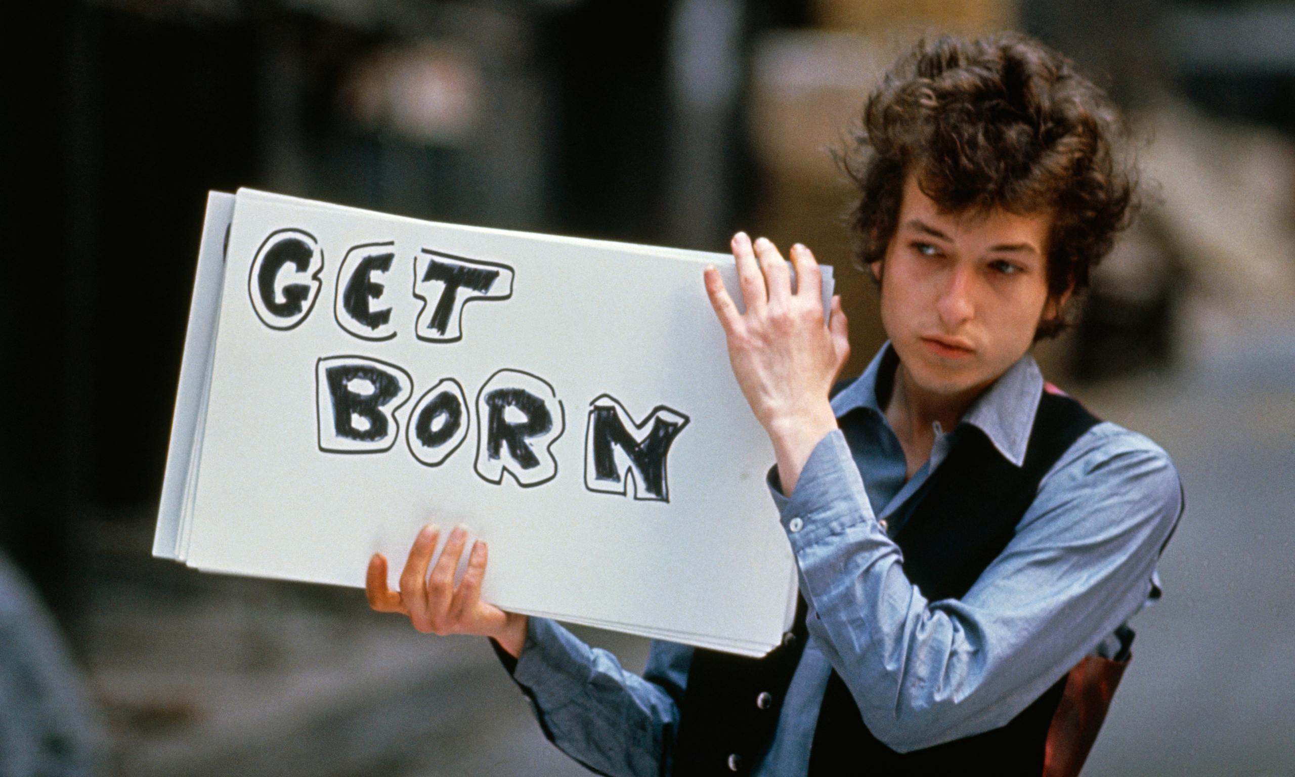 Bob Dylan with Get Born sign